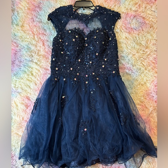 Dark blue prom dress. Zip back. Size 4. Sequin tops. Sheer bottom. Wore once. - Picture 2 of 3